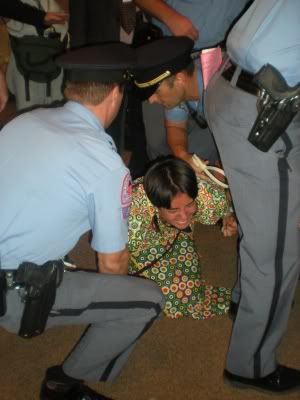 Protester resisting arrest at Wake County School Board meeting. Image courtesy Daily Tarheel