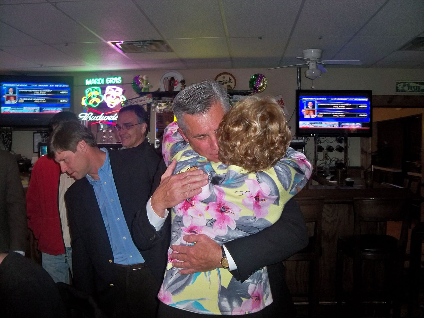 Jim and Judy Davis hug after his victory becomes apparent 
Photo by Bobby Coggins