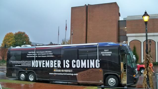 The November is Coming bus outside the Macon County Courthouse