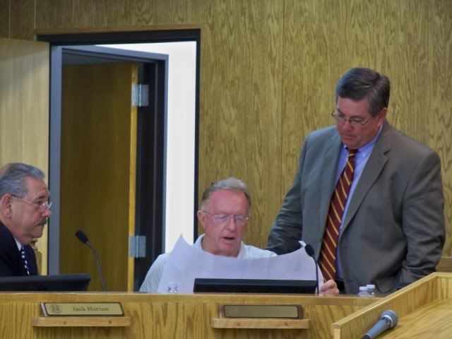 County Manager Jack Horton (L), County Commissioner Bob Simpson (C) and County Attorney Chester Jones (R) review construction blueprints for a Town of Franklin easement request