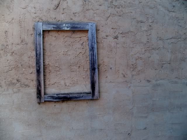 An empty picture frame hanging in an alley just off Main Street in Franklin, NC 
Photo by Bobby Coggins