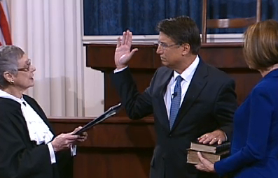 Justice Sarah Parker swears in Pat McCrory as his wife, Ann, looks on in Raliegh, NC