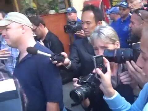 Screencap from a video showing an anonymous American exercising his Freedom of Speech 
Note the mob of reporters who are just shocked that such a man exists in this land of ours 
Screencap by Bobby Coggins
